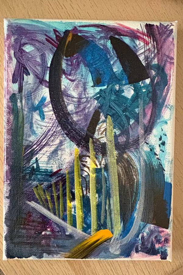 Abstract painting with colorful brush strokes on a wooden surface